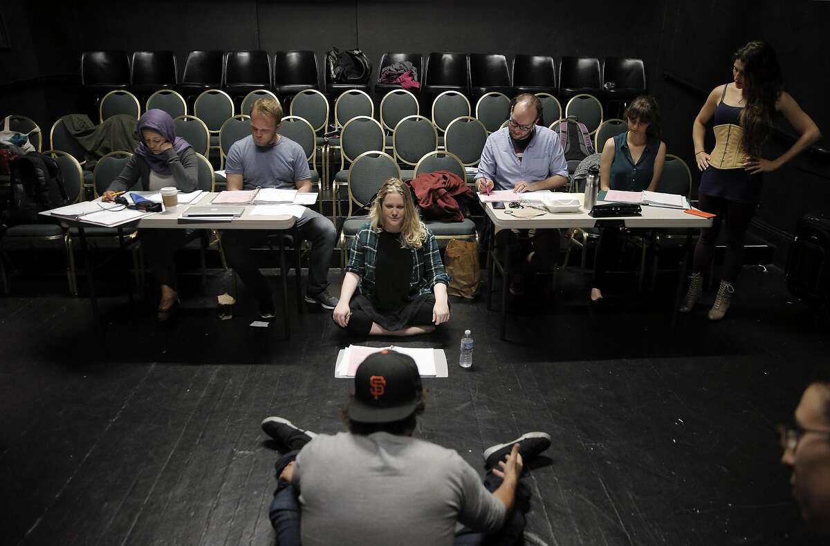 The Breadbox artistic director Ariel Craft, center, works with actors during rehearsal for The Awakening.