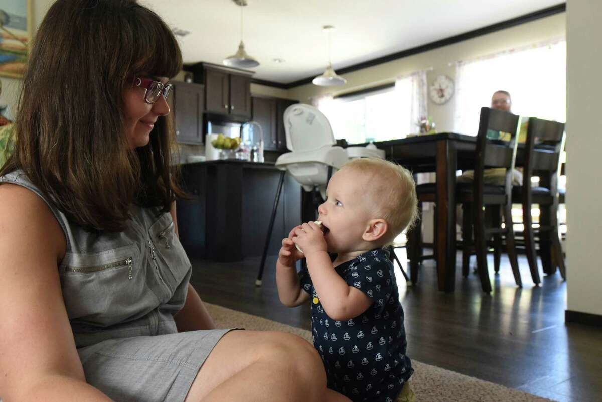 Hanna Nowak and her 1-year-old son, Bill, enjoy a moment at their home in Floresville. Hanna and her husband, Damian Nowak, currently pay almost $700 a month for a Blue Cross Blue Shield of Texas health insurance plan.