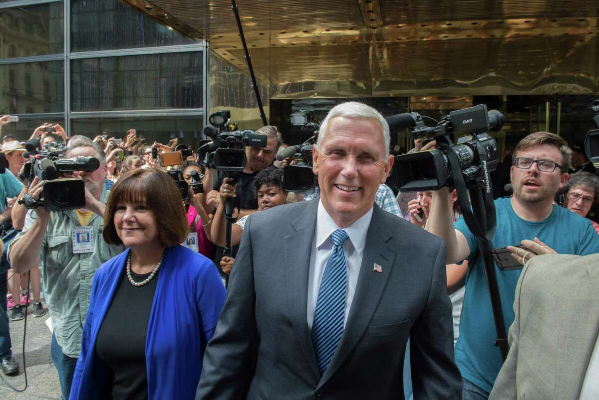 Gov. Mike Pence of Indiana and his wife, Karen, leave the Intercontinental Hotel in New York after a meeting with Donald Trump, who named his running mate.