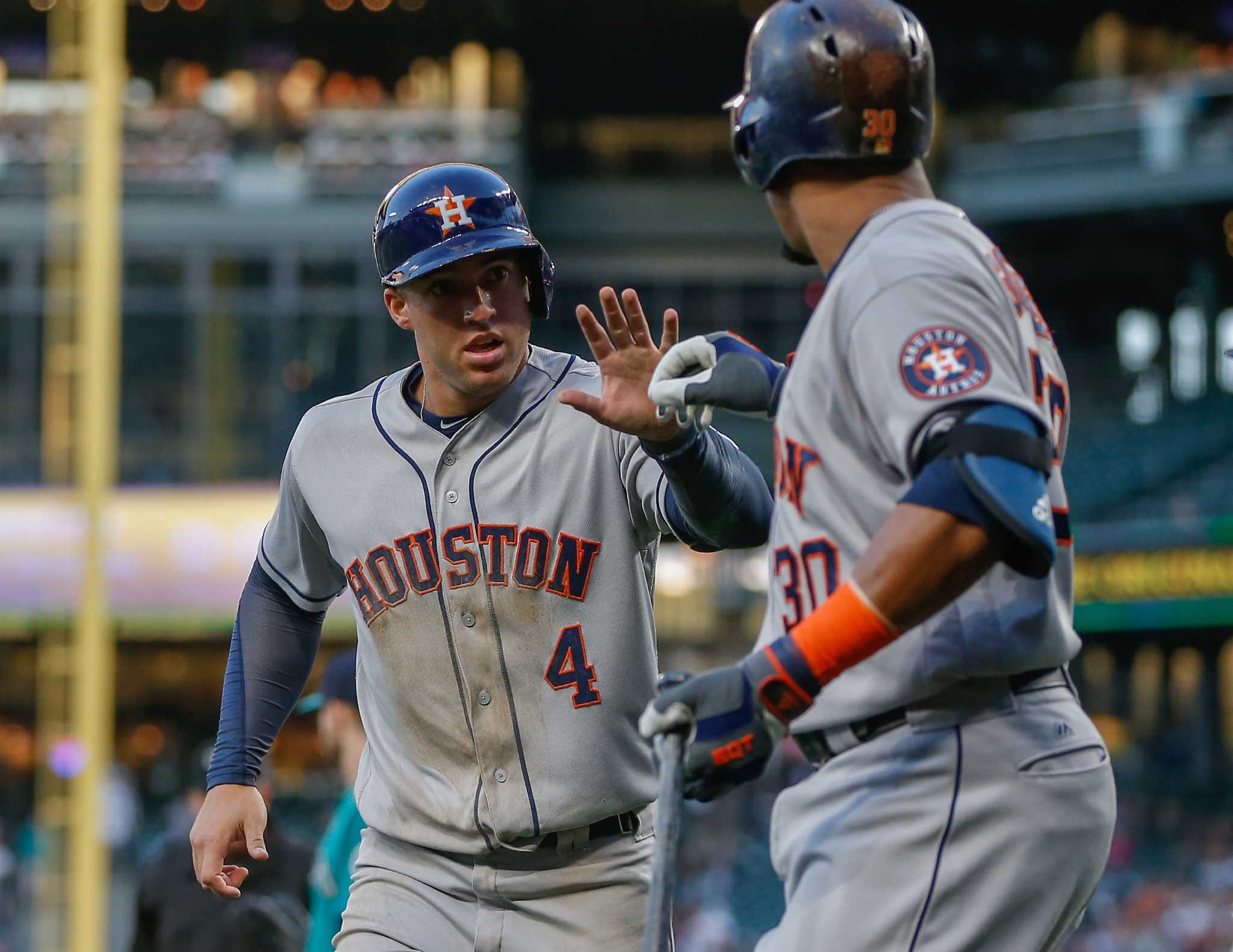 Houston Astros' Jake Marisnick, right, is congratulated in the dugout on  his two-run home run against the Los Angeles Dodgers during the second  inning of a baseball game Friday, Aug. 21, 2015