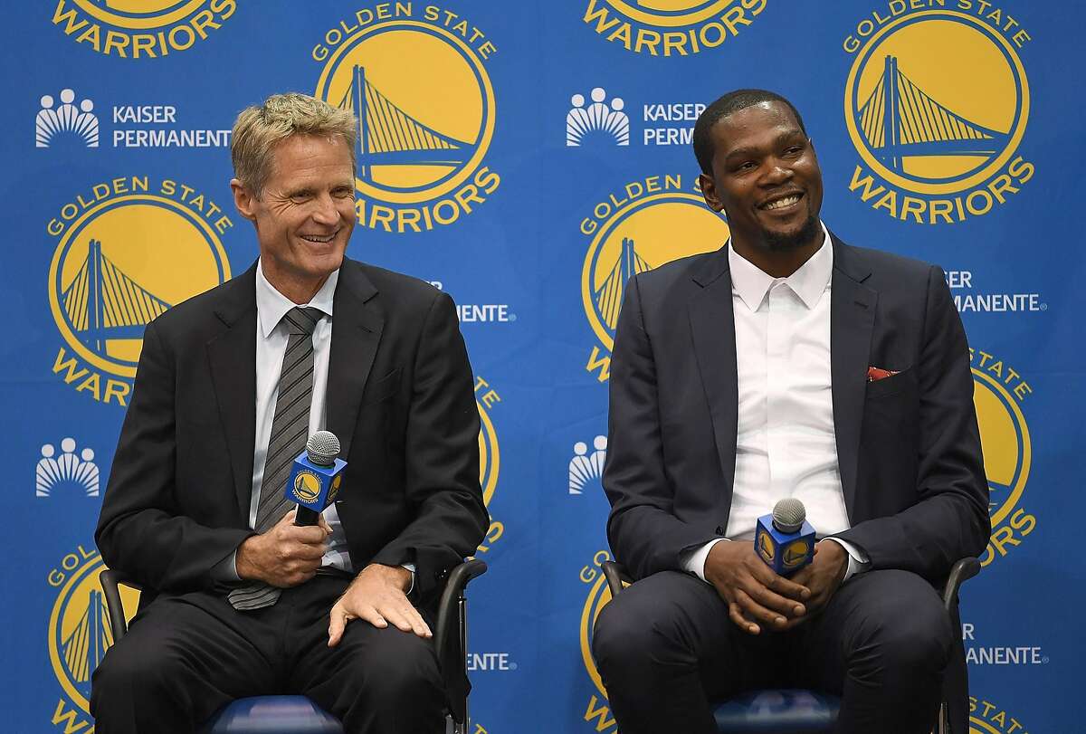 OAKLAND, CA - JULY 07: (L-R) Head coach Steve Kerr of the Golden State Warriors sits with Kevin Durant while they speak to the media during the press conference where Durant was introduced as a Golden State Warrior after they signed him as a free agent on July 7, 2016 in Oakland, California. (Photo by Thearon W. Henderson/Getty Images)