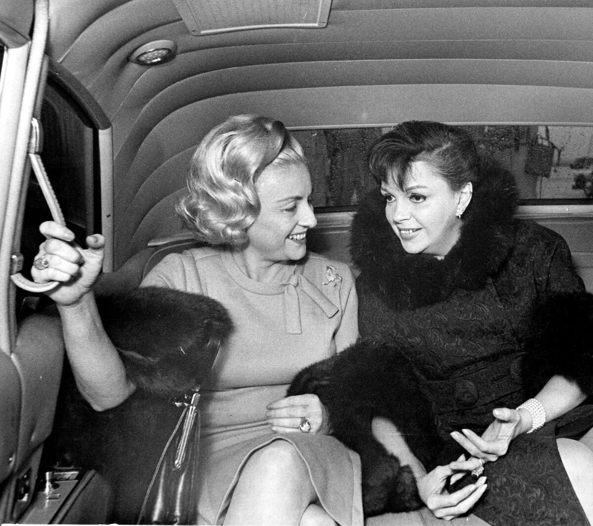 12/14/1965 - Houston Chronicle writer Maxine Mesinger shares a ride with singer Judy Garland leaving Houston International Airport.