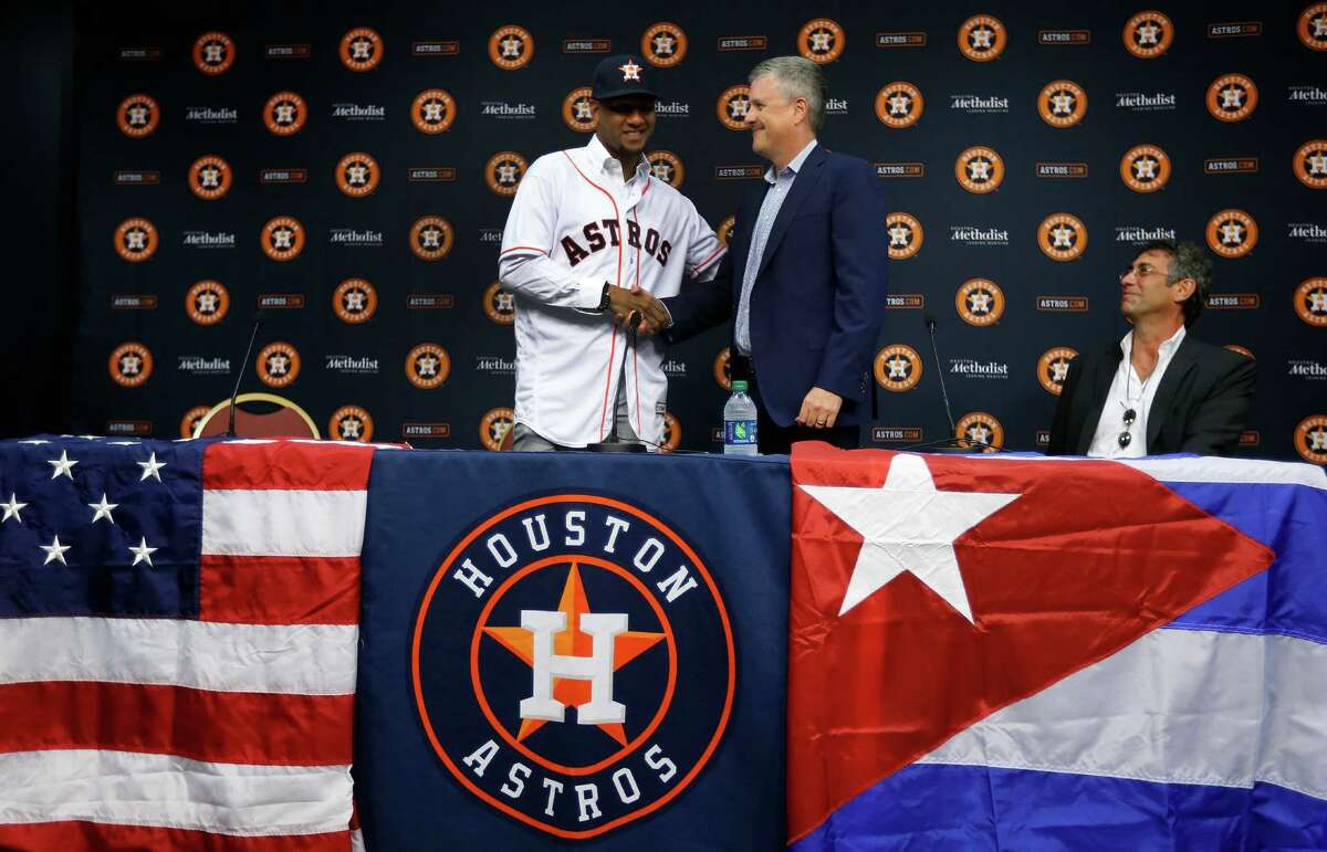 Cuban infielder Yulieski Gurriel is introduced to the media by Houston Astros General Manager Jeff Luhnow after they agreed to terms with him, Saturday, July 16, 2016, in Houston.