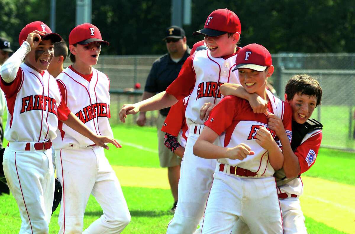 Fairfield American catcher Matt Vivona, right, puts his arm around pitcher Jack Gremse to celebrate the team's win over Trumbull National in District 2 little league tournament action at Unity Park in Trumbull, Conn. on Saturday July 15, 2016.