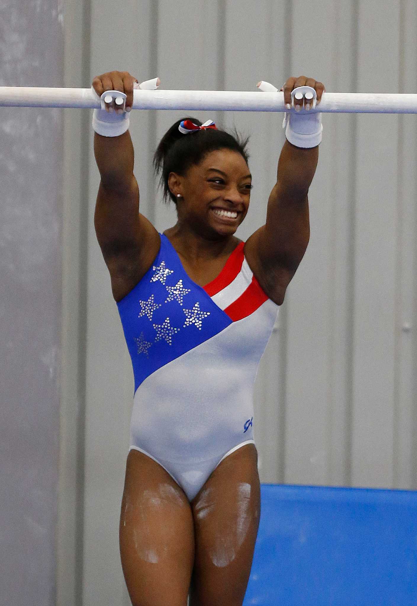 Simone Biles does flips around her Houston 10 competition.