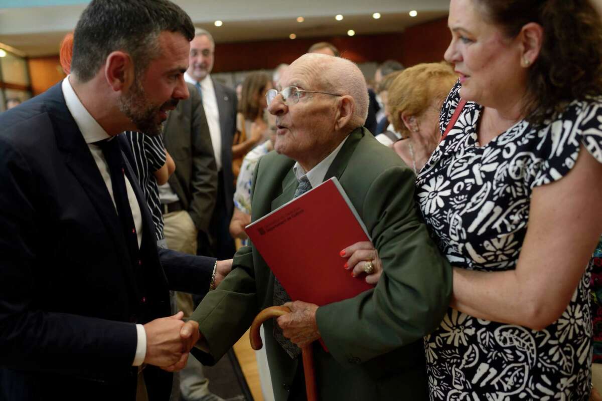 Family booklets and photos seized during the Spanish Civil War are returned to ﻿Pere Bartolomé at a ceremony ﻿this month in Sant Cugat, Spain. The ﻿93-year-old remembers the day Gen. Francisco Franco's soldiers ransacked his village. ﻿