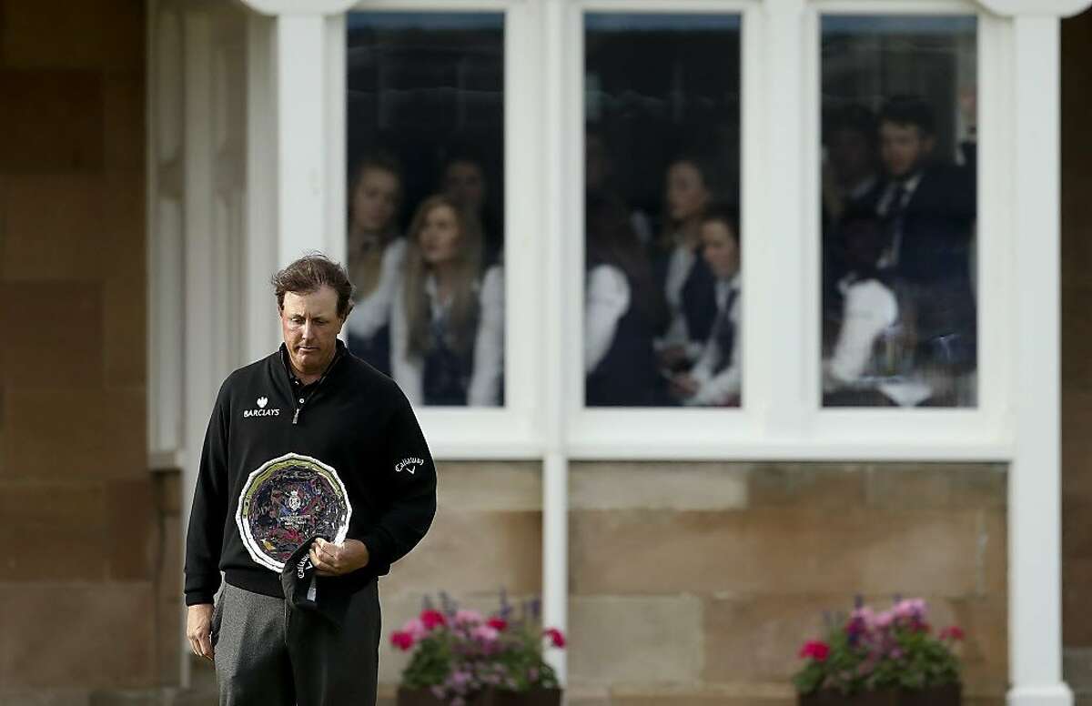 Phil Mickelson of the United States looks down as he holds the silver plate, for being runner up in the British Open Golf Championships at the Royal Troon Golf Club in Troon, Scotland, Sunday, July 17, 2016. Henrik Stenson the Championship. (AP Photo/Peter Morrison)