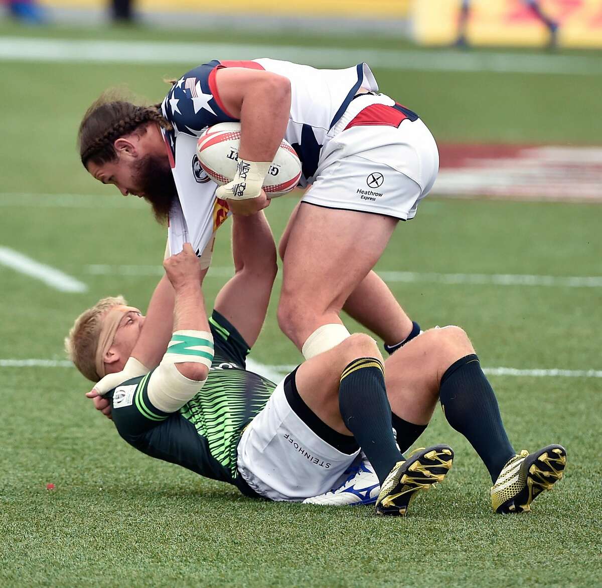 LAS VEGAS, NV - MARCH 05: Kyle Brown of South Africa (bottom) and Danny Barrett of the United States battle for the ball during the USA Sevens Rugby tournament at Sam Boyd Stadium on March 5, 2016 in Las Vegas, Nevada. (Photo by David Becker/Getty Images)
