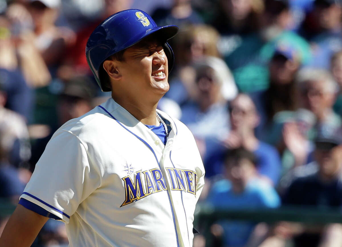 Seattle Mariners' Dae-Ho Lee reacts after being hit by a pitch thrown by Houston Astros reliever Chris Devenski in the eighth inning of a baseball game, Sunday, July 17, 2016, in Seattle. (AP Photo/Ted S. Warren)