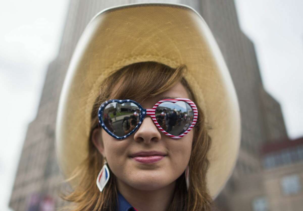 A Republican delegate poses for a photo as she waits to board a bus to the Quicken Loans Arena before the opening of the Republican National Convention on July 18, 2016 in Cleveland, Ohio. Thousands of delegates descend on a tightly secured Cleveland arena for the opening of the Republican National Convention, with Donald Trump's wife playing character witness as the tough-talking mogul seeks to lock up his party's presidential nomination. / AFP / Andrew CABALLERO-REYNOLDS (Photo credit should read ANDREW CABALLERO-REYNOLDS/AFP/Getty Images)