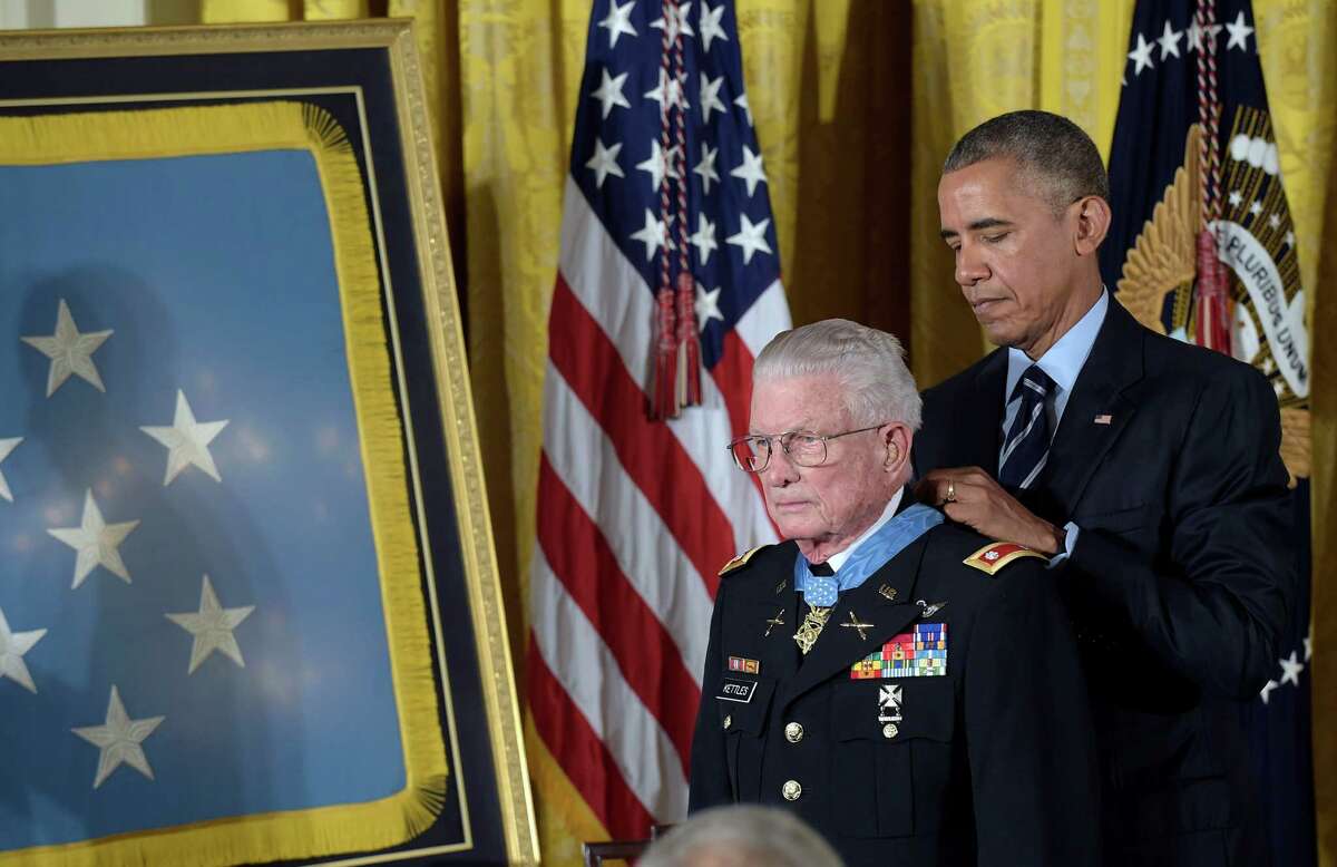 President Barack Obama presents the Medal of Honor to retired Army Lt. Col. Charles Kettles of Michigan during a ceremony in the East Room of the White House in Washington, Monday, July 18, 2016. Kettles distinguished himself in combat operations near Duc Pho, Vietnam, and is credited with saving the lives of 40 soldiers and four of his own crew members. (AP Photo/Susan Walsh)
