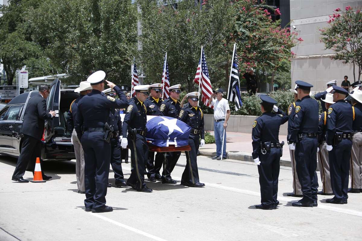 The casket of Bellaire Officer Anthony Zarate leaves the Co-Cathedral in Houston. Zarate was a Bellaire police officer who died last week while chasing two shoplifting suspects through a southwest Houston neighborhood.