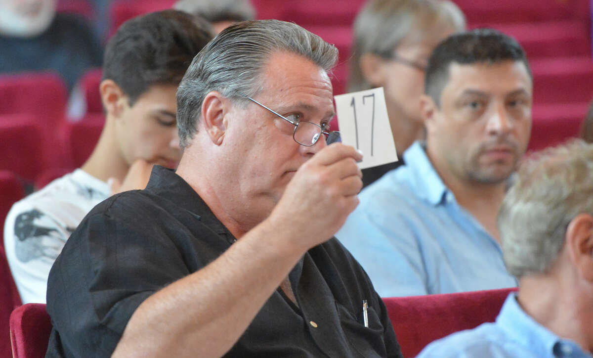 Registered bidders hold up bidder cards during a City of Norwalk property tax sale of about 18 Norwalk properties and some boat slips at City Hall on Monday July 18, 2016 in Norwalk Conn.