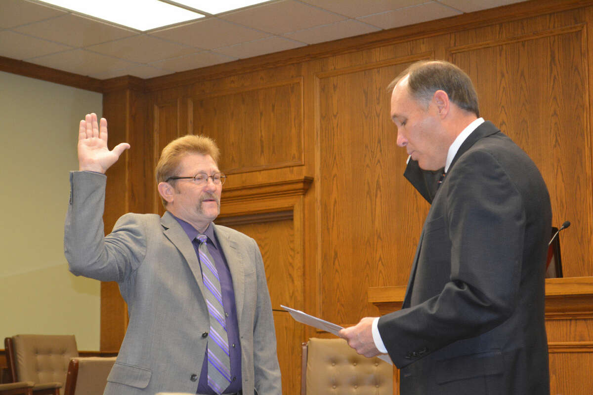 County JudgeDoug McDonough/Plainview HeraldCounty Judge Bill Coleman is administered his oath of office by District Judge Rob Kinkaid during a New Year’s Day ceremony on Thursday at the Hale County Courthouse. Coleman was re-elected in November.