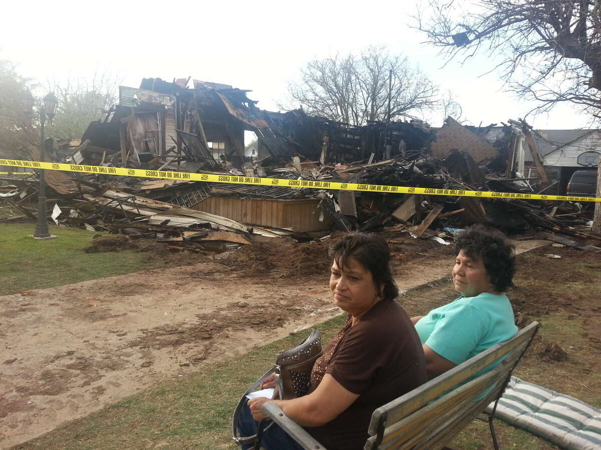 Genie Soto, left, and her mother, Juanita Garcia, survey the remains of Soto' s house at 712 W. Ninth St. that burned down Wednesday afternoon. The fire, the second one within 30 minutes in Plainview, was reported on the second floor of the residence. No one was injured, but the home was a complete loss.