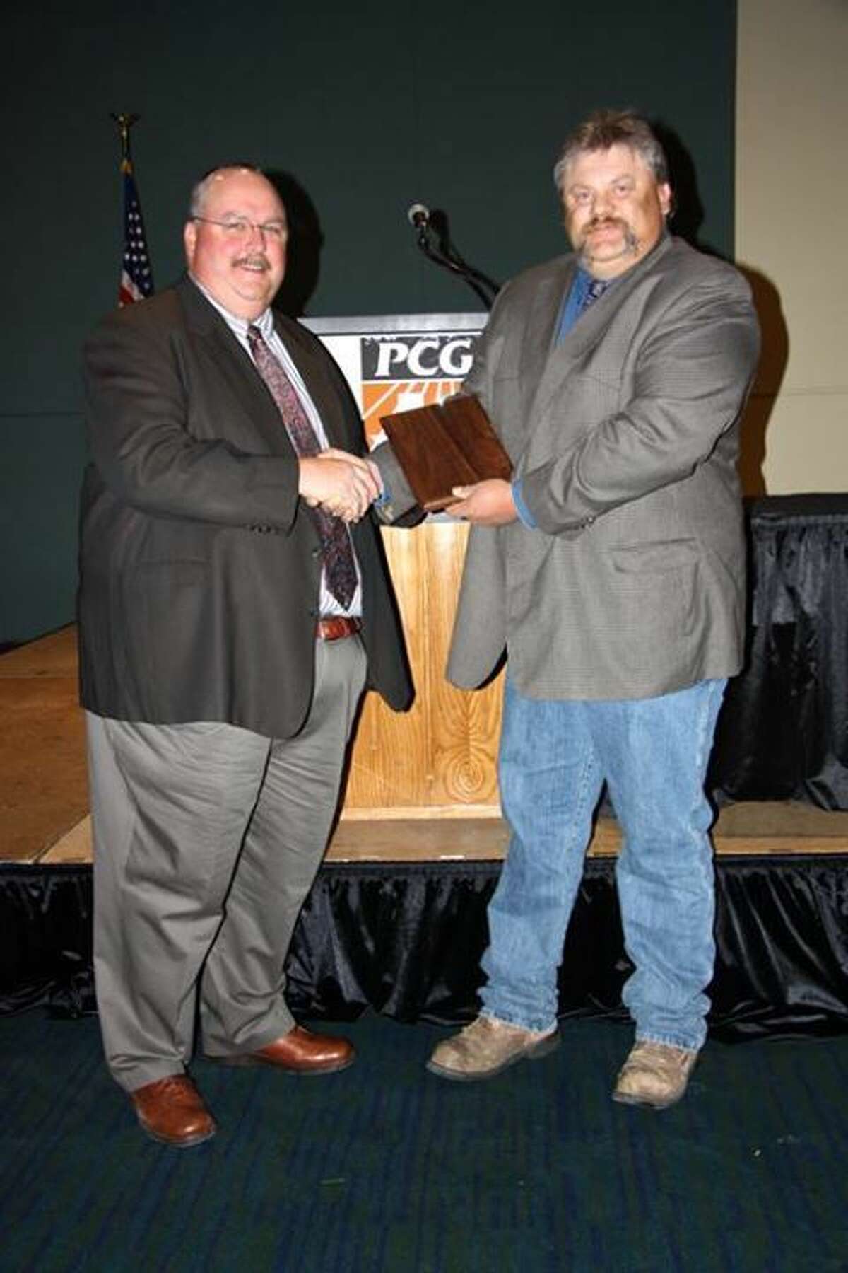 Outstanding Cotton AgentCourtesy Photo/Plains Cotton GrowersBlayne Reed (right) AgriLife Extension Integrated Pest Management agent for Hale, Swisher and Floyd counties, receives the Plains Cotton Growers Outstanding Cotton Agent Award from PCG President Shawn Holladay. In making the presentation during PCG’s annual meeting last week, Holladay said, “Blayne does an outstanding job of utilizing resources and partnering with individuals such as seed companies, producer associations, Extension Specialists, AgriLife Researchers, local businesses, consultants, and many others to make programs successful."