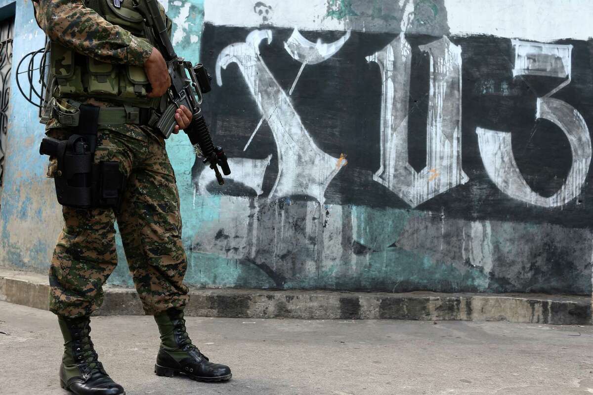 Members of the Salvadoran military and the Policia Nacional Civil patrol the alleys of the Colonia Jardin de Don Bosco in San Salvador, El Salvador, Wednesday, April 6, 2016. The neighborhood, like others in El Salvador, is home to two of the most powerful gangs in the country, MS-13 and Barrio 18. During their security detail, the soldiers will question young men and women in order to ascertain if they have a gang affiliation. There were no arrests during the operation.