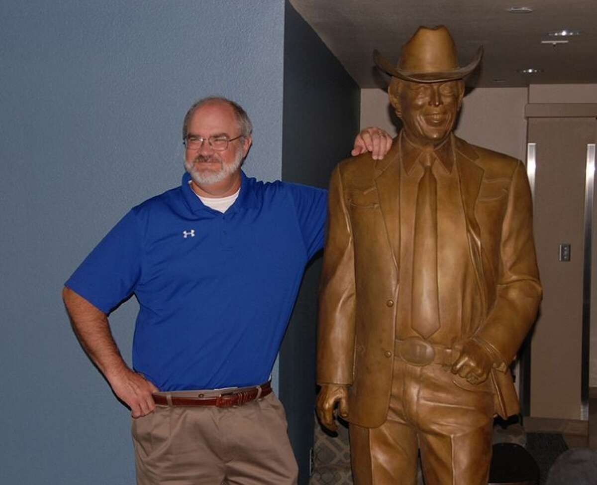 Jonathan Petty/Wayland Baptist UniversityWayland Baptist University Vice President of Enrollment Management Dr. Claude Lusk poses with the Jimmy Dean statue once it is set up and secure in Jimmy Dean Hall.