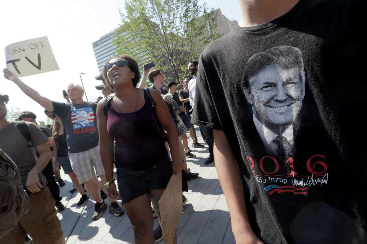 A Black Live Matter protestors shouts slogans standing next to next to a supporter of Republican presidential candidate Donald Trump in Public Square on Tuesday, July 19, 2016, in Cleveland, during the second day of the Republican convention. (AP Photo/Mary Altaffer)