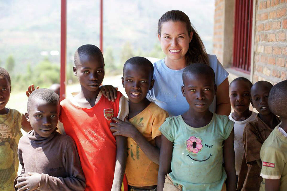Linnea Davis, a Stanwich librarian, poses with students from the Blessing School in Rwanda. Davis and other staff members, along with two groups of students, spent weeks in the country helping build and renovate the school.