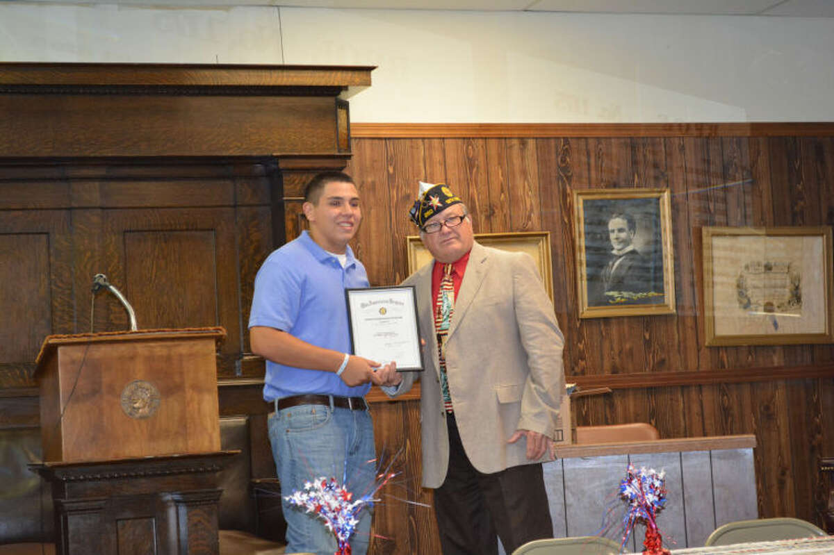 American Legion District Commander Ralph Langley presents a certificate to Richard Salinas in recognition of his participation in Boys State this summer during the annual local Boys State and Girls State Banquet on Friday. Other area participants in Boys State this year include Johnny Barry, Steven Espinosa, Calvin Rodriguez and Anthony Morales. Local Girls State sponsors were the Elks Lodge and Drs. Webb and Webb. Boys State sponsors included Stoerner-Bybee Farms, Kiwanis Club, Halfway Farm Chemical, J.B. & Associates, Turpen Insurance, Quarterway Gin, Inc., Ray Lee Equipment and Kornerstone Funeral Directors.