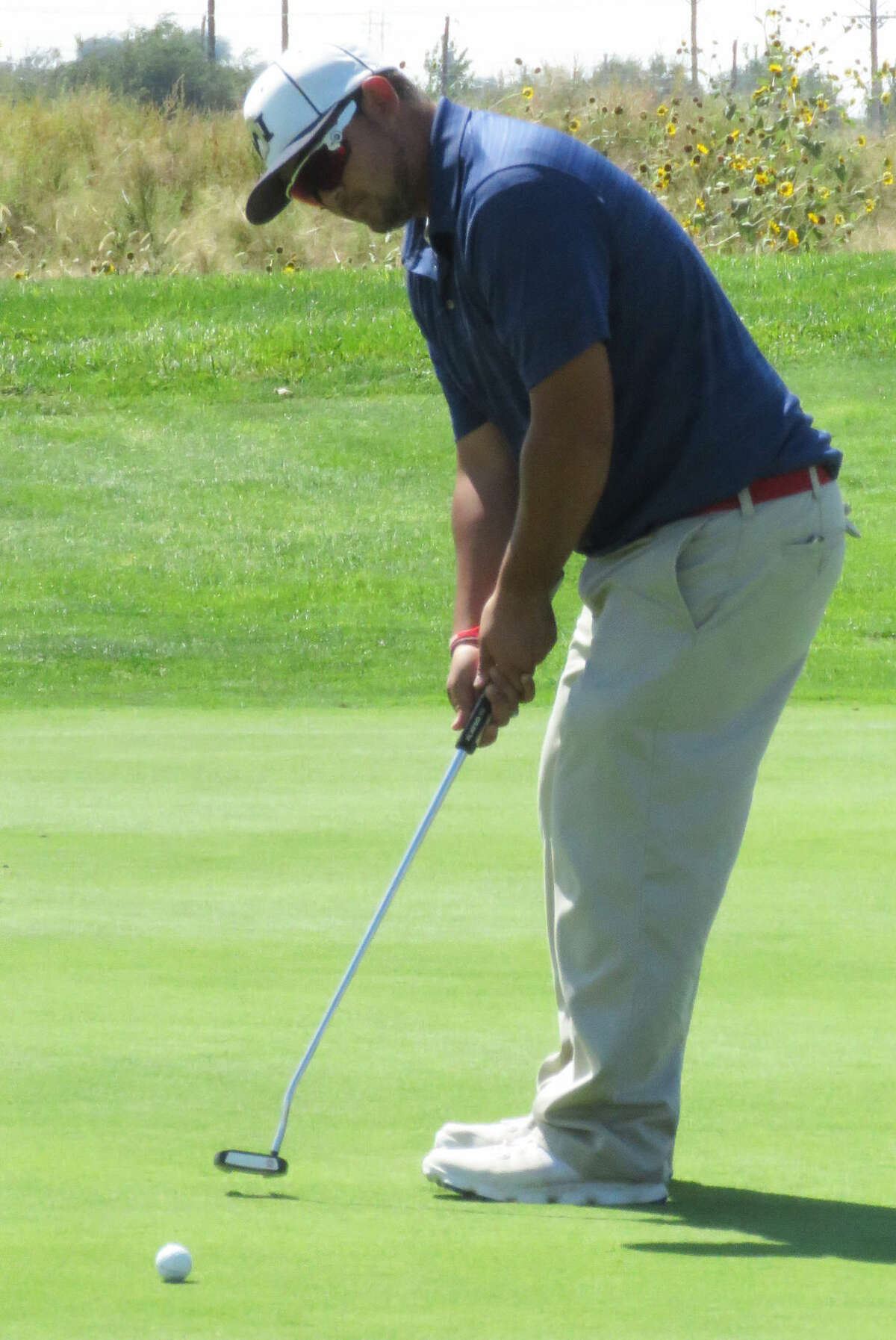 Plainview's Troy Velasquez putts the ball during the Amarillo Triangular at Comanche Golf Course Saturday. Velasquez was one of three Bulldogs to shoot a 74 as they finished with a 294 team score, which was the low score of all teams for the day.
