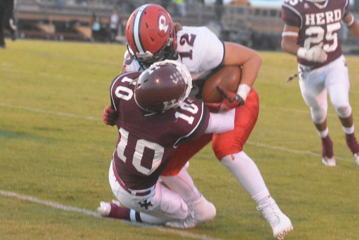 Plainview running back Wrangler Haresnape (12) tries to bowl over a Hereford defender during last week's final non-district football game. The Bulldogs, who sport a 3-3 record, are off this week before they begin District 4-5A play at Abilene Cooper Oct. 16.