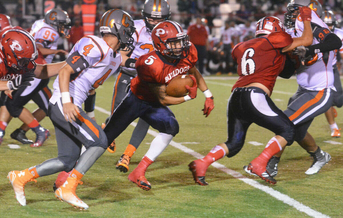 Plainview running back Warren Flye (5) races through the Caprock defense as teammate Domingo Saucedo (6) throws a block in front of him during the Bulldogs' victory over the Longhorns Friday. Flye scored on touchdown runs of 45, 76 and 84 yards and caught a 94-yard touchdown pass in the win.