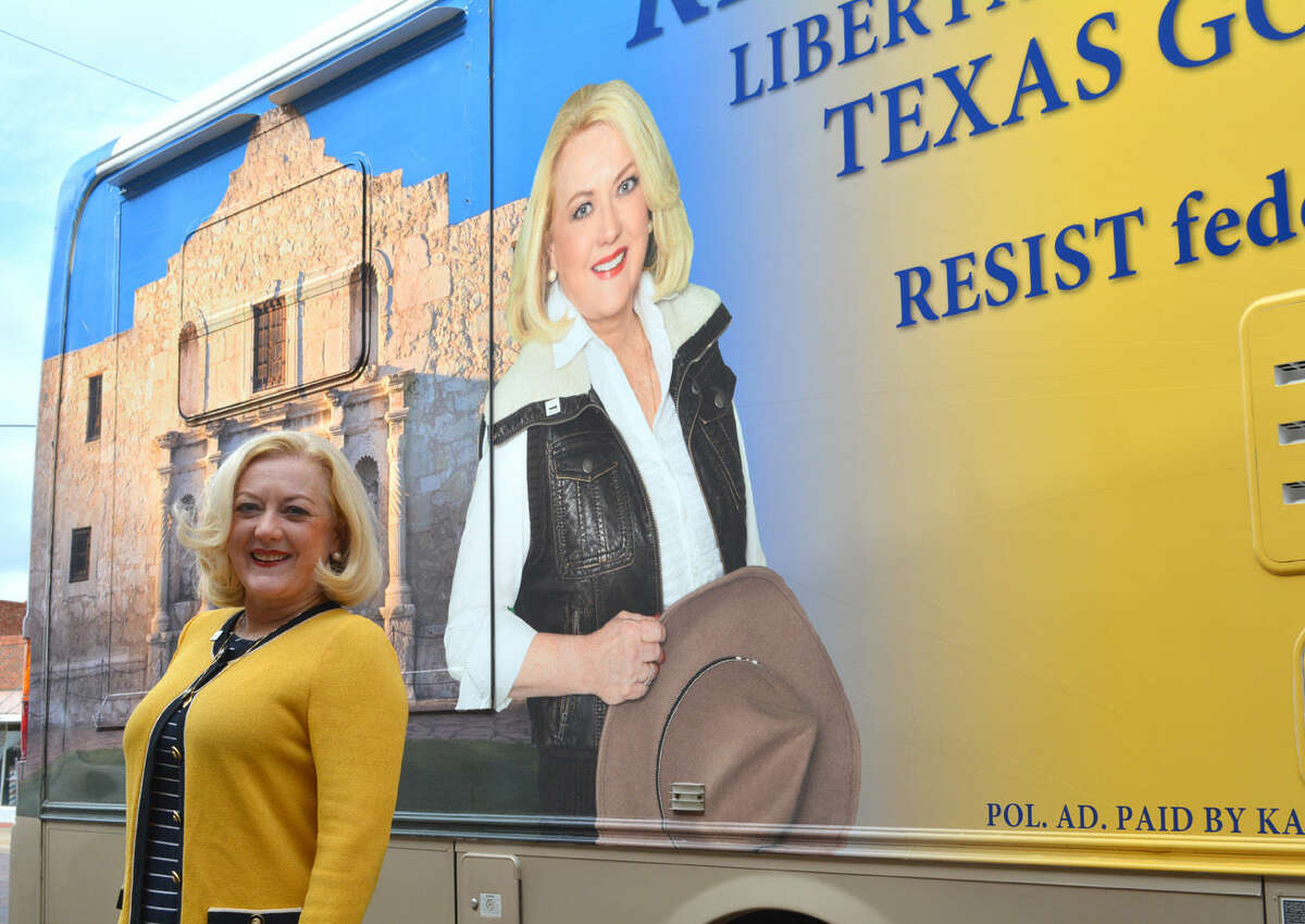 Libertarian candidate Kathie Glass, the Libertarian nominee for Texas governor, stands beside her tour bus during a campaign stop in Plainview on Monday. She is in the process of touring all 254 Texas counties.