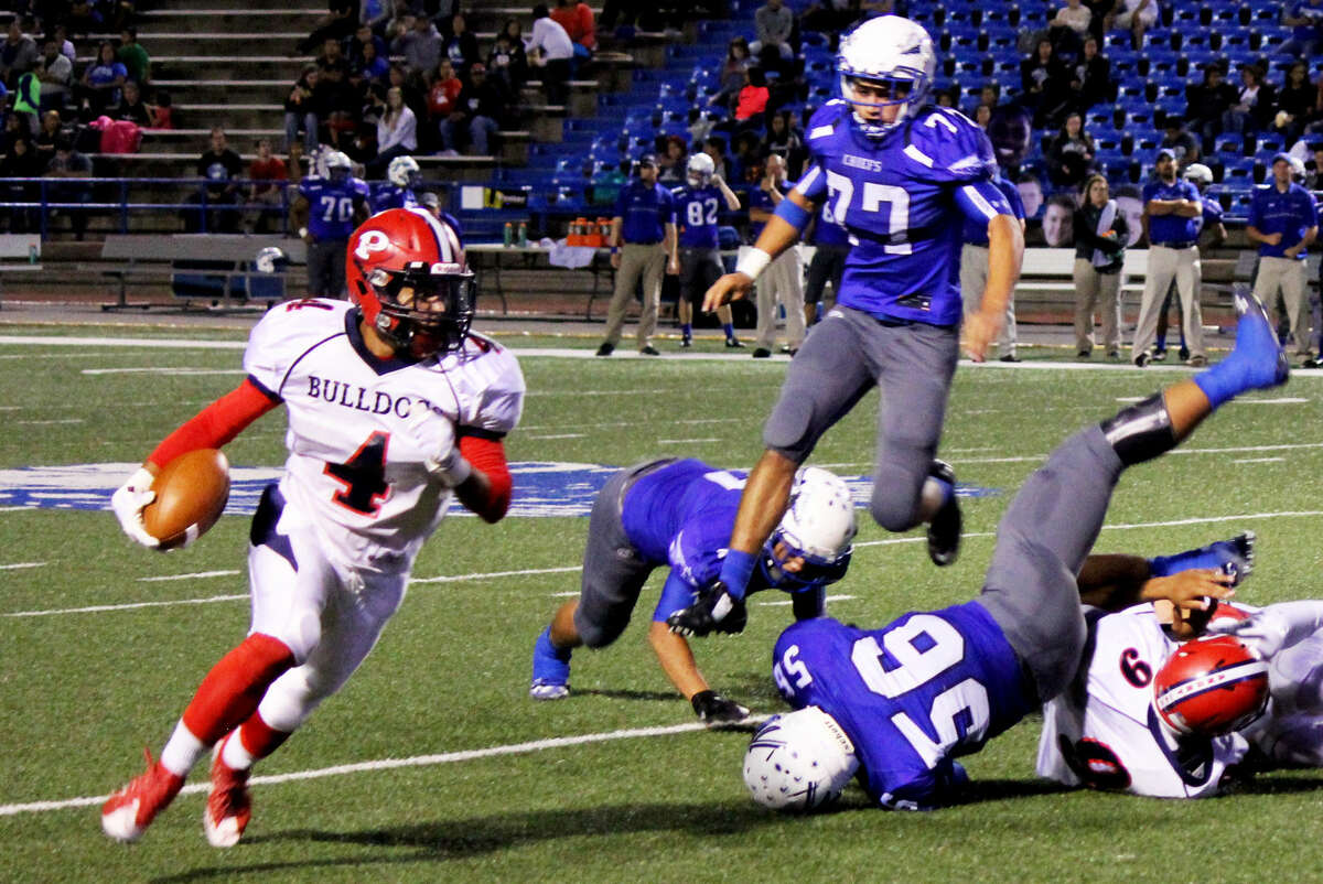 Plainview running back Trendan Jackson turns the corner and gains yardage as San Angelo Lake View players are scattered on the field during Friday's game in San Angelo. Bulldog quarterback Marc Ramos (9) throws a block to spring Jackson.