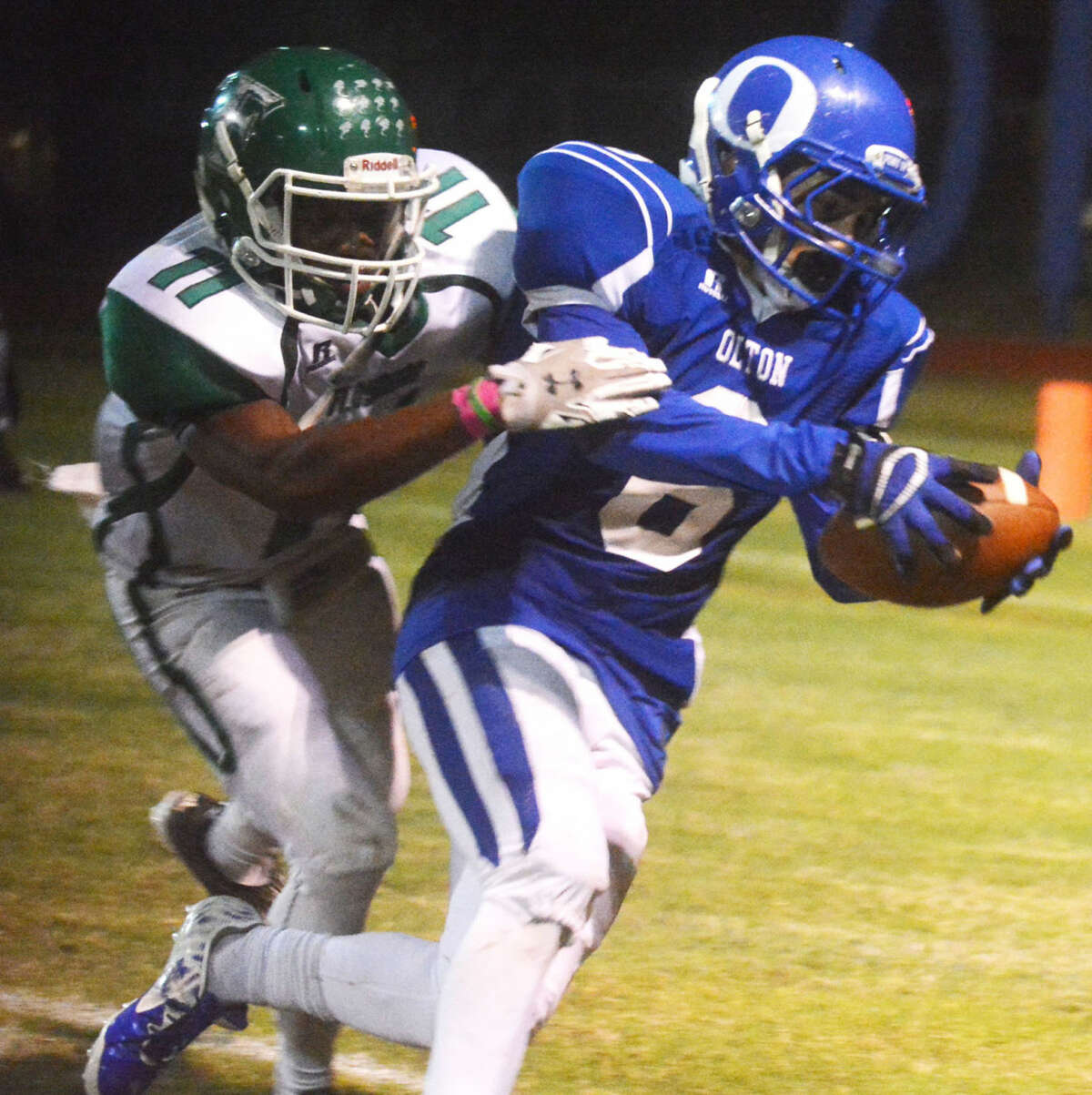 Olton's Bryan Valencia (6) tries to escape the grasp of Floydada's Kyi Baker (11) during a game earlier this season. Valencia has been moved from receiver to running back and has helped spark the Mustangs the past two weeks. Olton and Hale Center play Friday night with the winner qualifying for the playoffs.