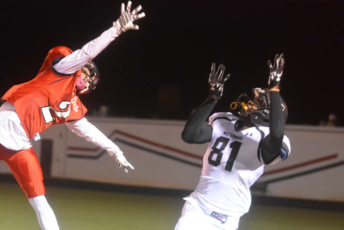 Plainview defensive back Jayton Ellis (left) leaps high to defend a pass intended for Lubbock High's Devante Greathouse last week. The Bulldogs host Randall in a bi-district playoff game Friday night.