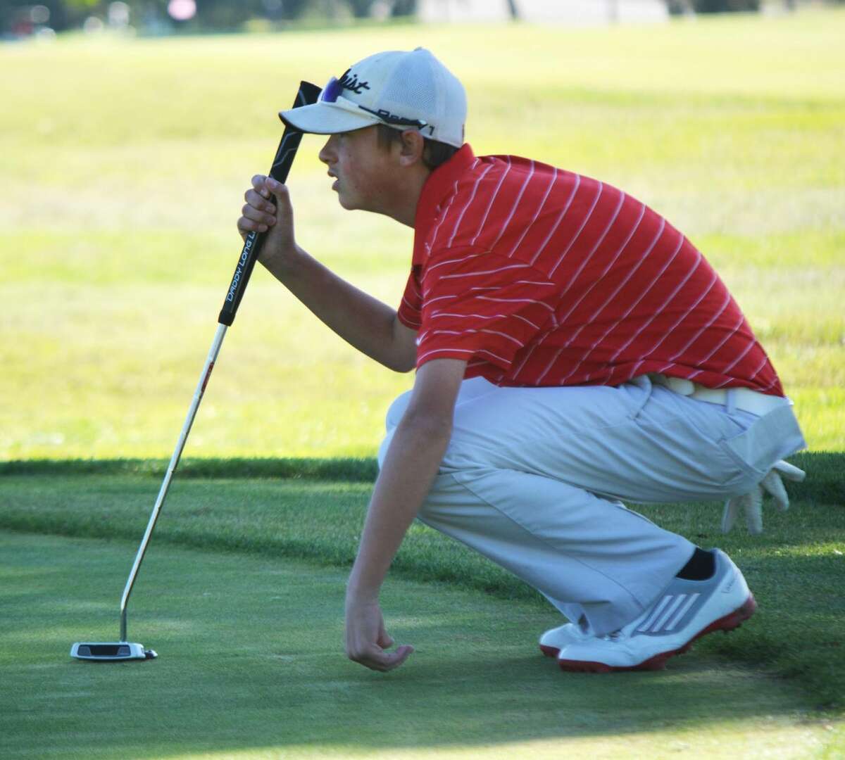 Plainview golfer Zach McDonough lines up a putt during the Plainview Triangular at the Plainview Country Club Saturday. McDonough led the Bulldogs' 'B' team with a 91.