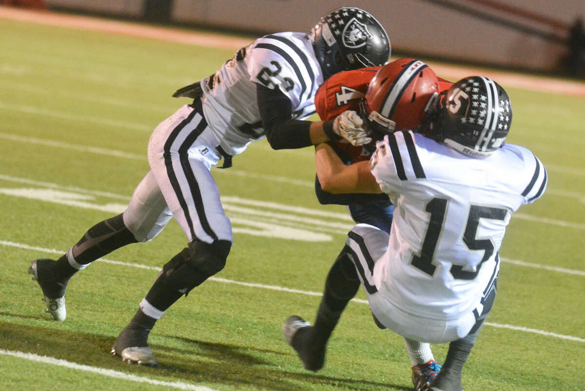Plainview running back Trendan Jackson (4) is tackled by two Randall players during a bi-district playoff game earlier this month. The Bulldogs have been to the playoffs two years in a row. They could face a bit more of a challenge next season if Lubbock Monterey and Lubbock Coronado drop to 5A and enter the district.