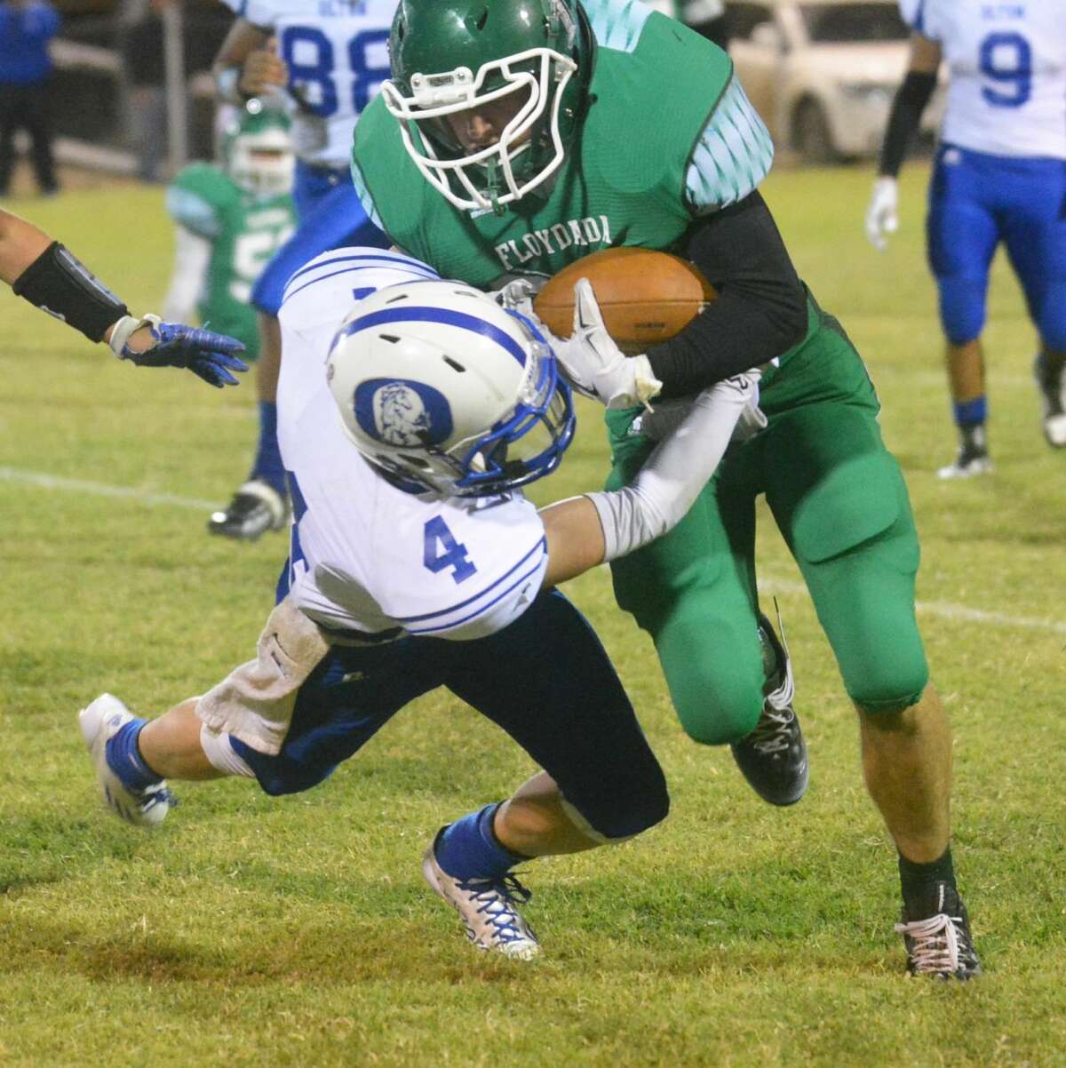 Floydada running back Corbin Nutt tries to run over Olton tackler Kyle Peggram during a District 2-2A Division I football game Friday night. Nutt rushed for 92 yards on 20 carries to help the Whirlwinds to a 24-19 victory.