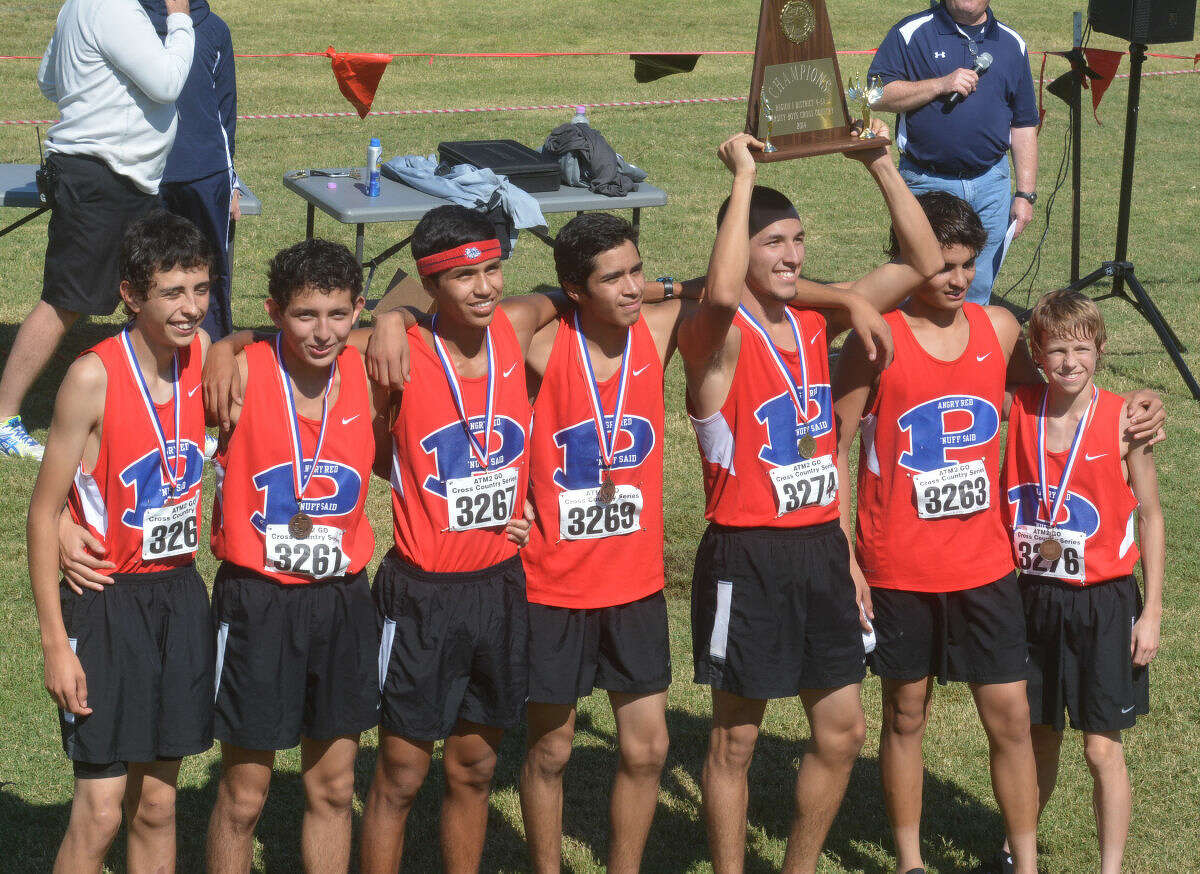 The Plainview boys cross country team poses with the District 4-5A championship plaque they earned Thursday. It was the second consecutive district title for the Bulldogs.