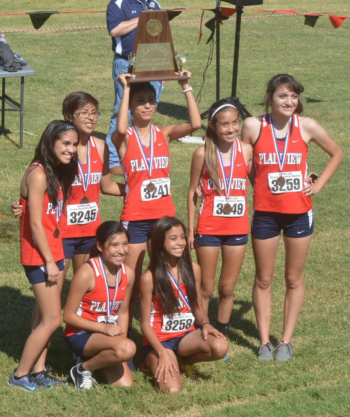 The Plainview girls cross country team poses with the District 4-5A championship plaque they earned at the district meet Thursday. The Lady Bulldogs were one of four team champions for Plainview.