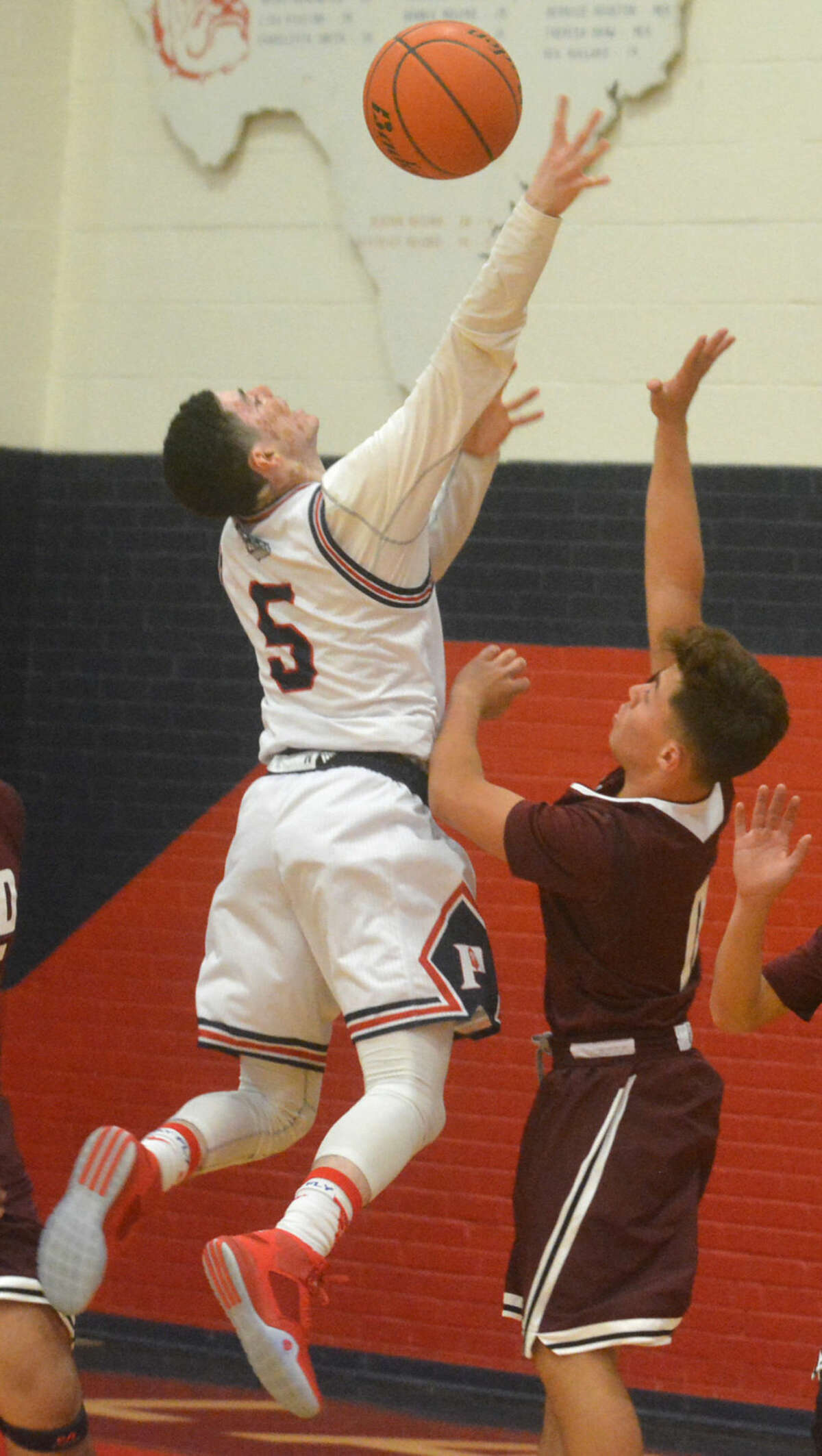 Plainview point guard Jayton Ellis (5) is fouled as he goes up for a shot during a game against Hereford Tuesday night. Ellis scored nine points to help the Bulldogs to a 69-64 victory to raise their record to 10-3.