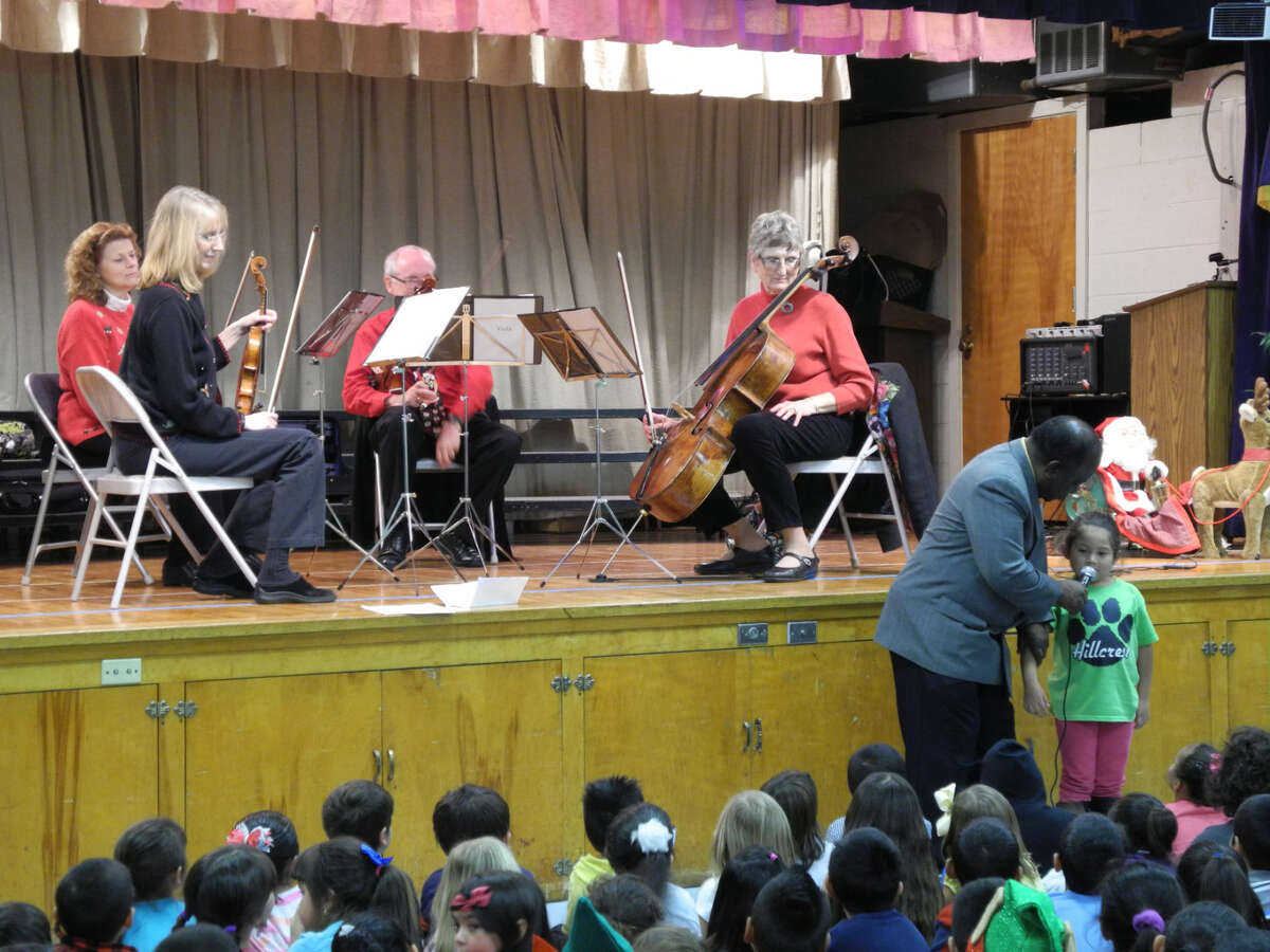 Plainview Symphony Orchestra President Joe Berry invited children to stand or come to the front and participate at the Plainview Symphony Orchestra Kinderconcert at Hillcrest Elementary Wednesday. Here a student introduces the string quartet members.