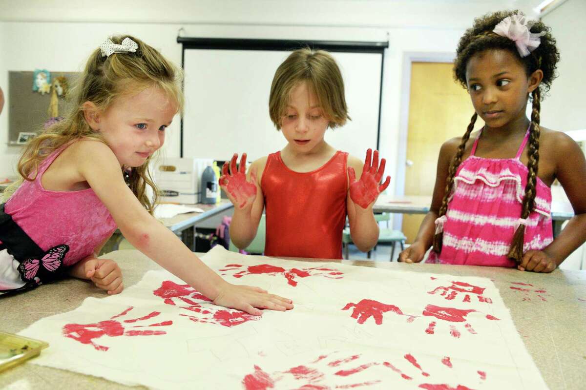 Vivian Domas, left, 5, of Chatham, Evelyn Shirer, 6, of Albany and Sydney Burd, 7, right, of Schenectady make their own stage backdrop during Kids on Stage summer camp at the Theatre Institute at Russell Sage College Wednesday July 20, 2016 in Troy, NY. (John Carl D'Annibale / Times Union)