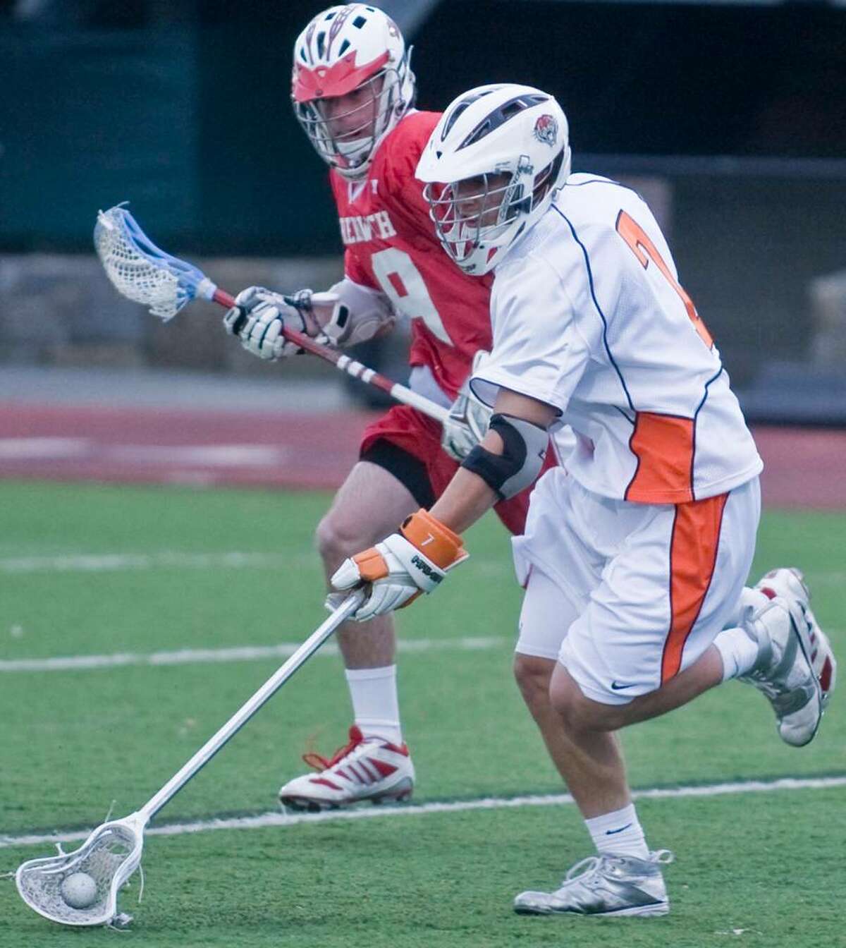 Greenwich High's Stephen Dodd and Ridgefield's Sean Riley pace each other during a boys lacrosse game at Ridgefield. Tuesday, April 27, 2010