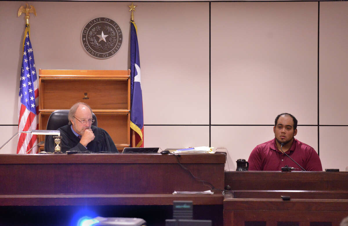 Michael Ramos (right) testifies Wednesday in the 225th State District Court of Judge Sid Harle (left) during the capital murder trial of Dominique Green.