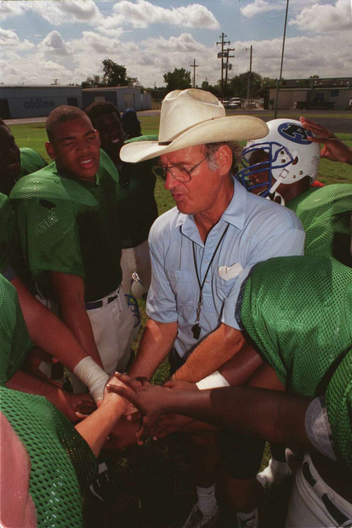 Aldine coach Bill Smith, who is going for his 200th coaching victory on Friday, concludes his team's practice, Monday (9/6/99), with a joined hands pep talk. Photo by Steve Ueckert / Chronicle HOUCHRON CAPTION (09/07/1999): Aldine coach Bill Smith tried to maintain a business-as-usual approach at practice Monday.