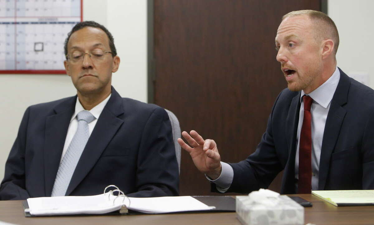 Craig Clopton, left, a former HCSO homicide Sgt. who was fired last year for having sexual contact with a witness in the fatal shooting of Deputy Darren Goforth, listens as his attorney Carson Joachim, right, speaks during a civil service commission Thursday, July 21, 2016, in Houston. The commission upheld the sheriff's decision to terminate his employment.
