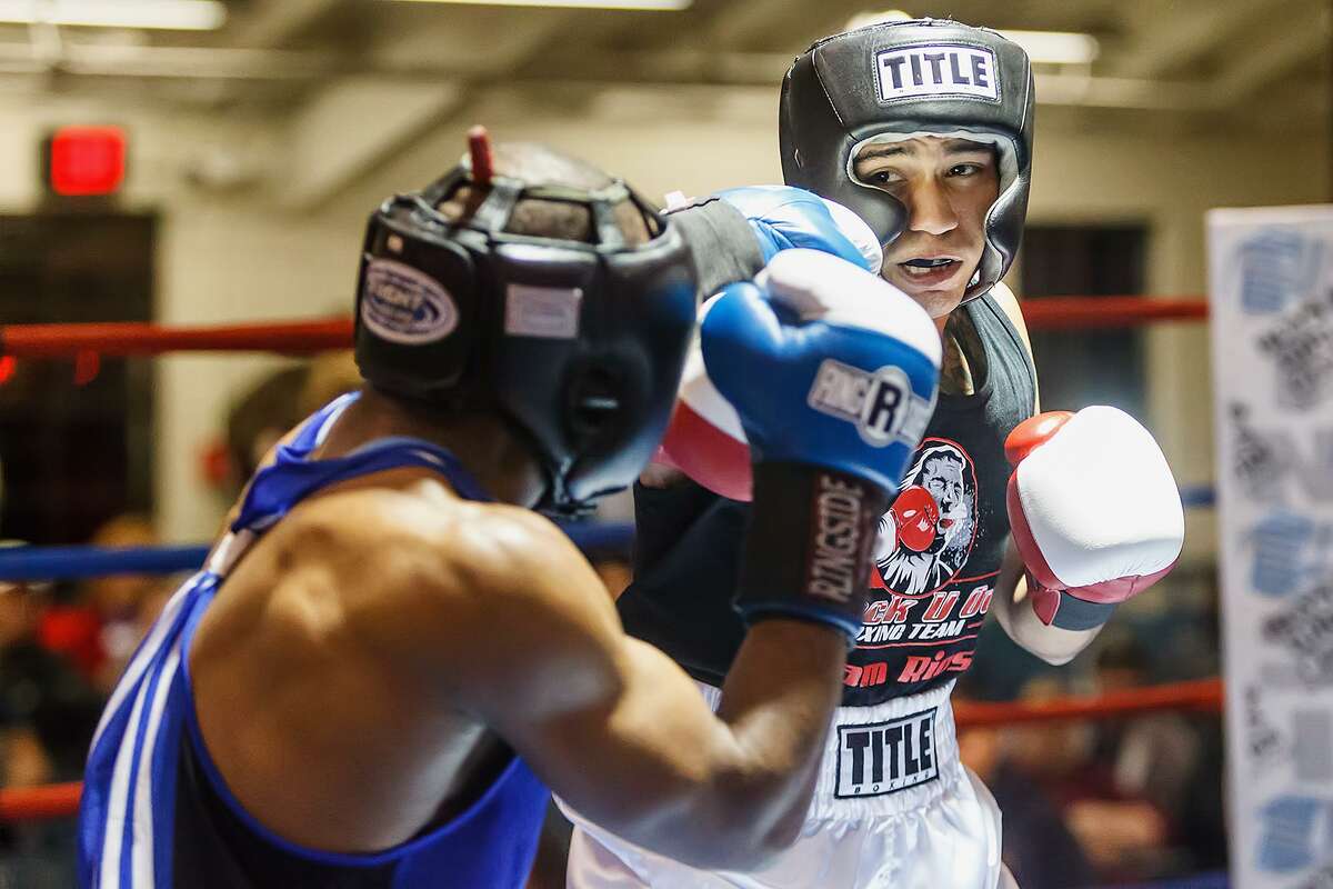 Daniel Baiz looks for an opening in James Beck’s defense during their open welterweight bout on opening night of the 2013 San Antonio Regional Golden Gloves tournament at Woodlawn Gym on Feb. 19, 2013.