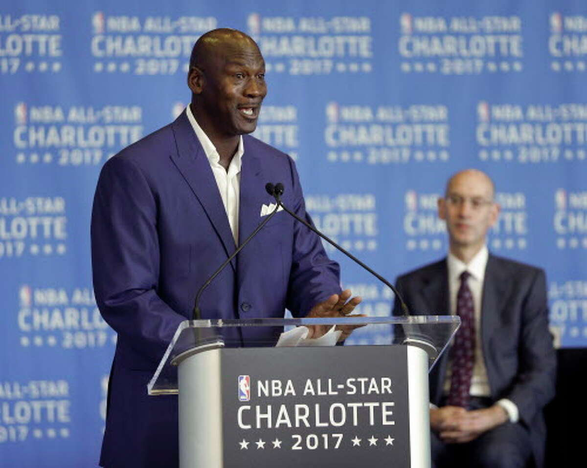 Charlotte Hornets owner Michael Jordan, left, speaks as NBA Commissioner Adam Silver, right, listens during a news conference, Tuesday, June 23, 2015, to announce Charlotte, N.C., as the site of the 2017 NBA All-Star basketball game. (AP Photo/Chuck Burton)