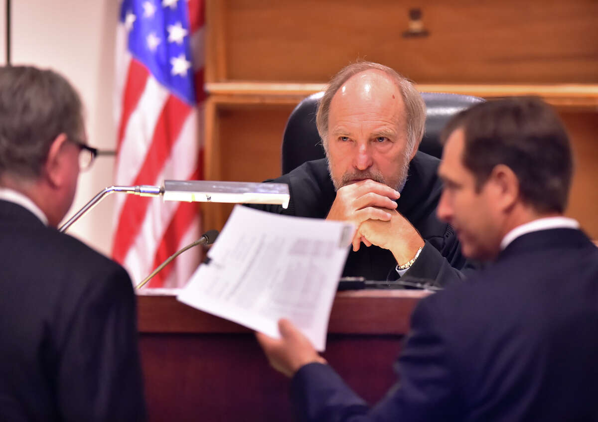 Judge Sid Harle of the 226th State District Courtlistens to defense attorney Richard Langlois (left) and prosecutor Geoff Barr during the capital murder trial of Dominique Green Wednesday.