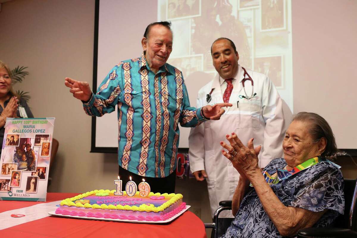 Flaco Jimenez serenades Maria Gallegos Lopez with birthday wishes as Dr. Richard Prezas looks on. She’s the oldest WellMed patient in South and Central Texas, the health care company said.