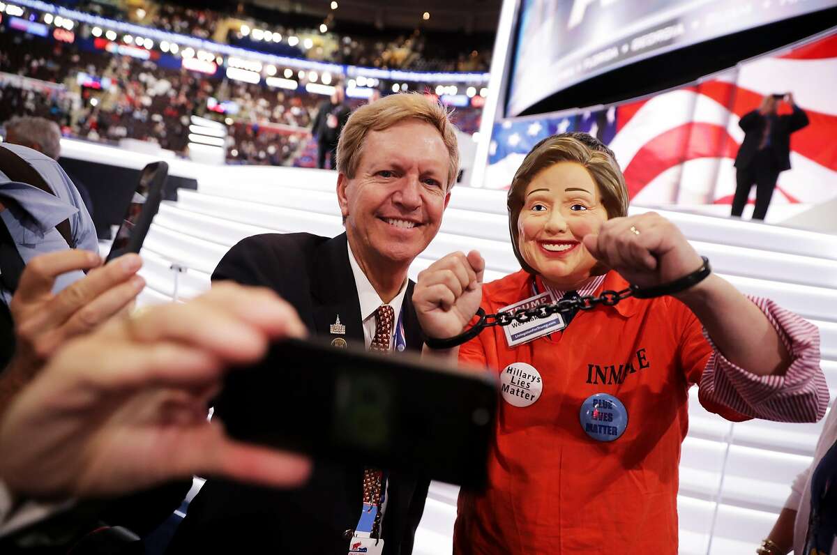 CLEVELAND, OH - JULY 21: Attendee Wes Nakagiri, dressed as US Democratic presidential candidate Hillary Clinton, takes a selfie with a delegate prior to the start on the fourth day of the Republican National Convention on July 21, 2016 at the Quicken Loans Arena in Cleveland, Ohio. Republican presidential candidate Donald Trump received the number of votes needed to secure the party's nomination. An estimated 50,000 people are expected in Cleveland, including hundreds of protesters and members of the media. The four-day Republican National Convention kicked off on July 18. (Photo by Chip Somodevilla/Getty Images)