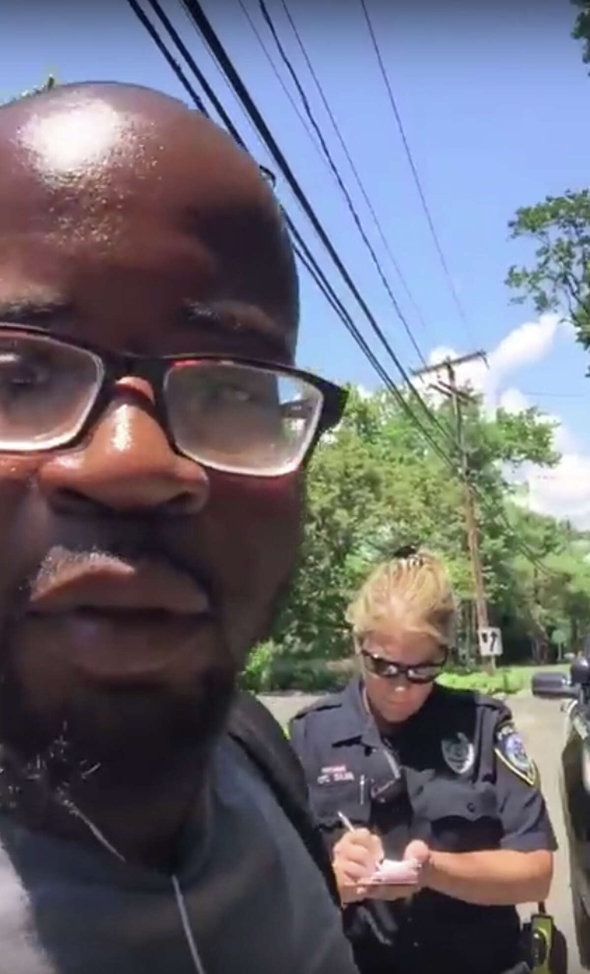 A white Darien police officer questions a black man who was riding his bike to his job at Tokeneke Country Club. A video of the incident has gone viral.